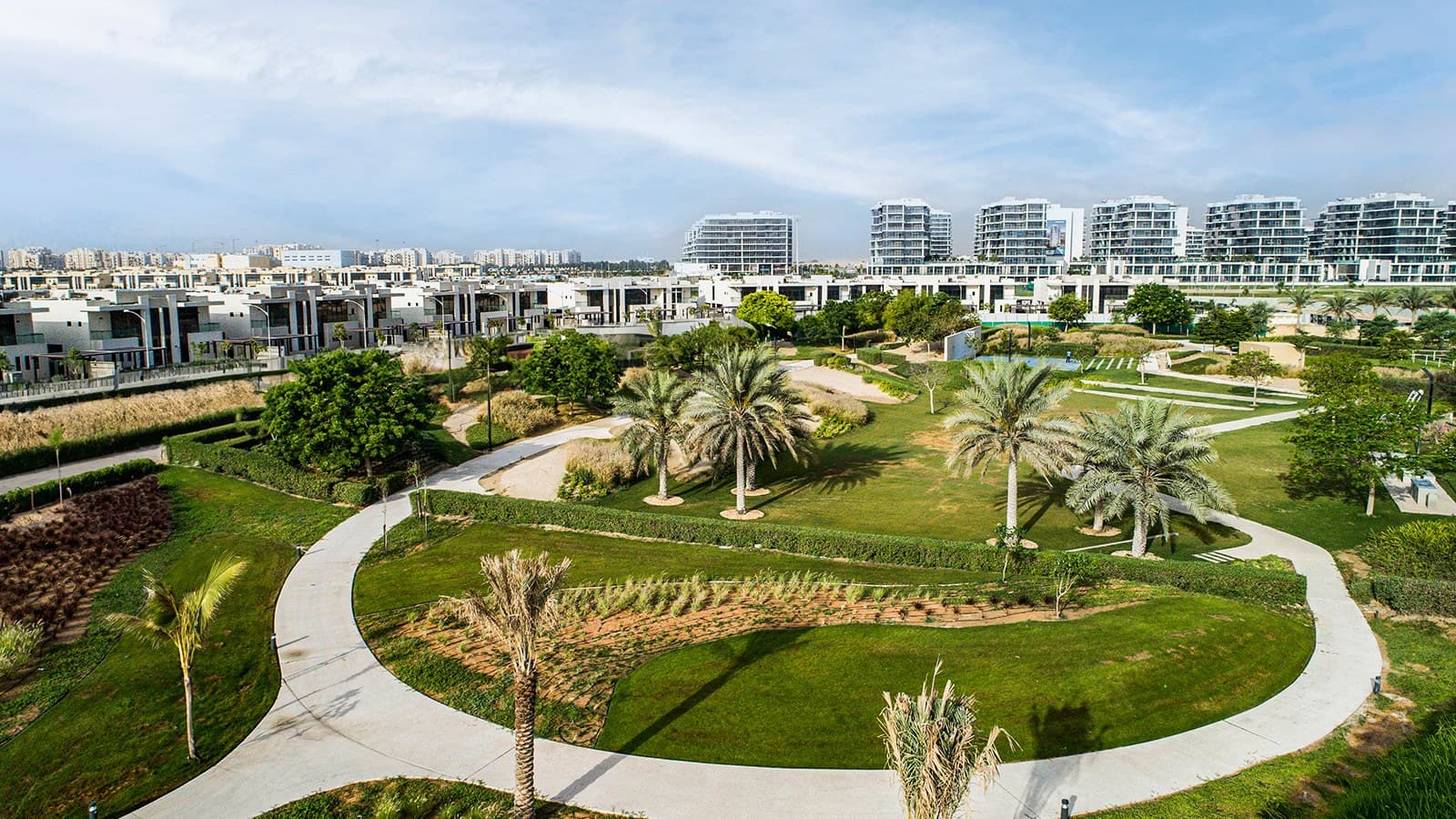 Landscaped park, villas and apartment buildings in DAMAC Hills