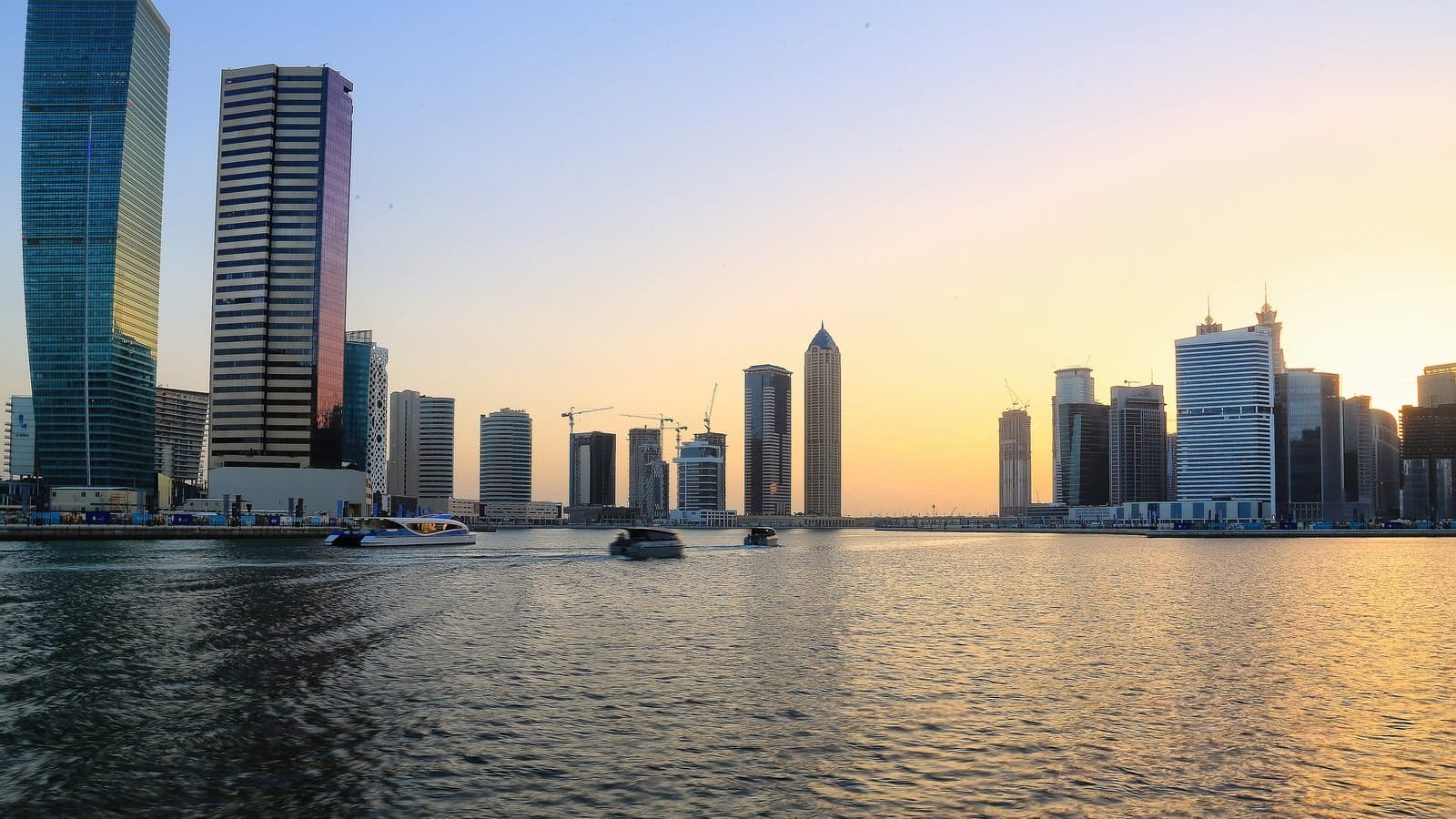 Business Bay towers on the Dubai Water Canal at sunset