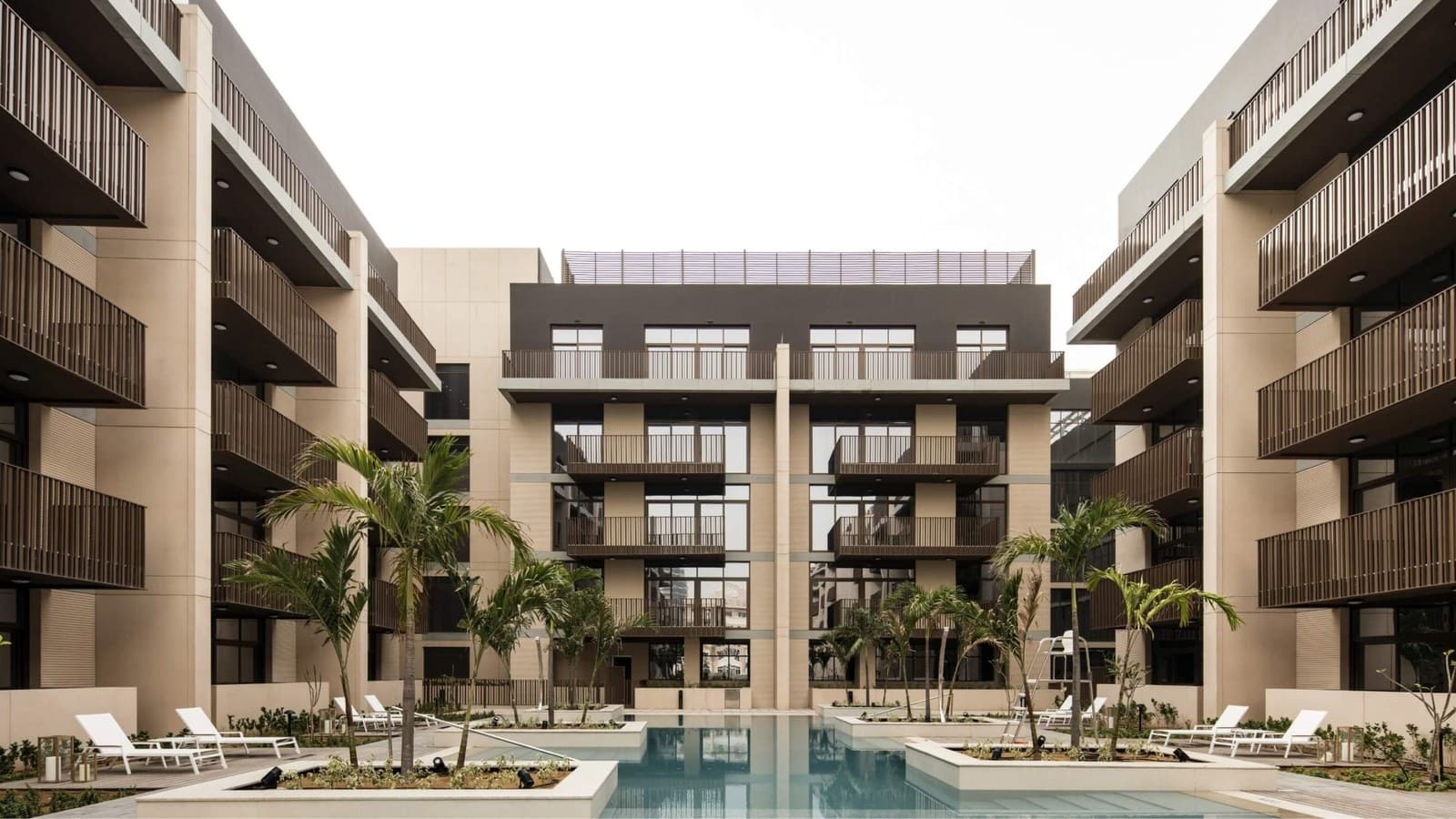 Belgravia apartment buildings around the courtyard swimming pool in Jumeirah Village Circle
