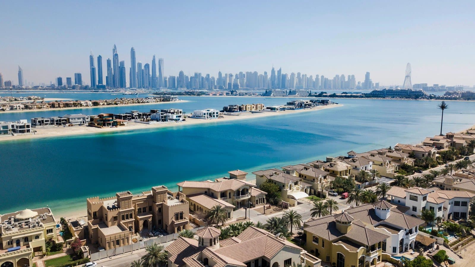 Palm Jumeirah frond villas with the Dubai skyline beyond